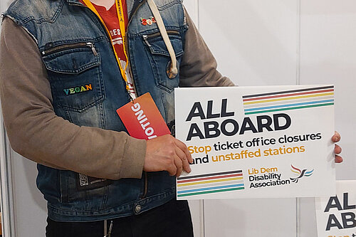 James Archer holds up the All Aboard campaigns board at conference.